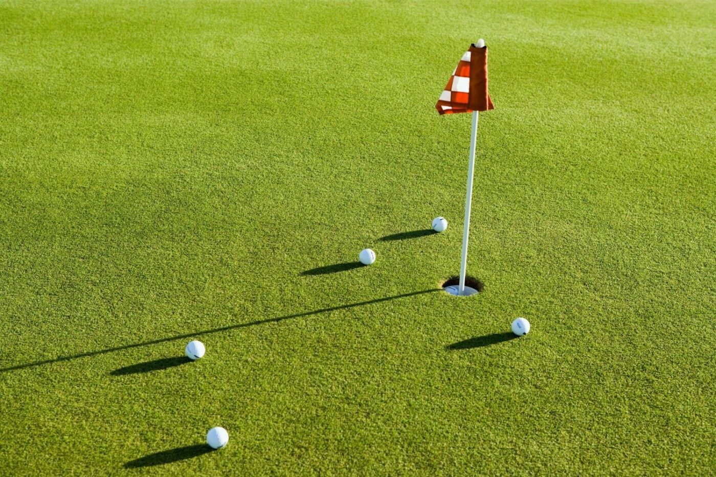 golf balls laid around the newly installed putting green in Jacksonville Beach FL