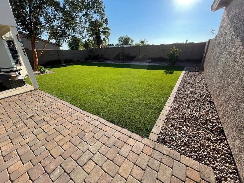artificial turf with paving stone patio and border in Jacksonville FL